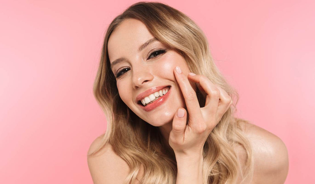 Young Woman Looking at Skin While Collagen Banking for her Skincare Routine.