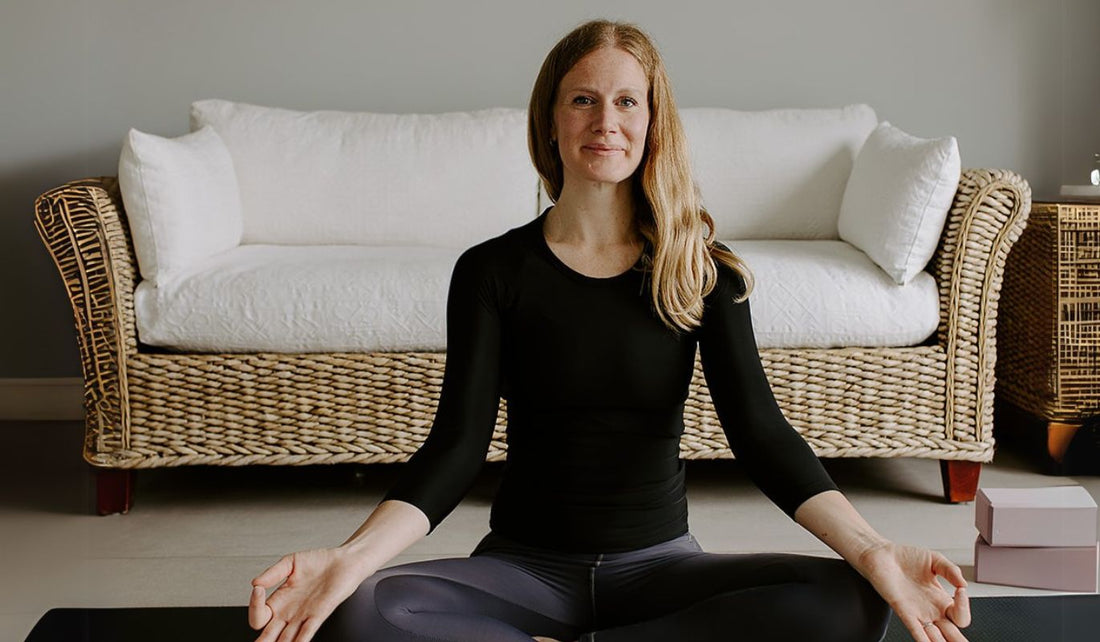 Charlotte King, a yoga teacher, practicing mindfulness and restorative yoga for tension relief and well-being.